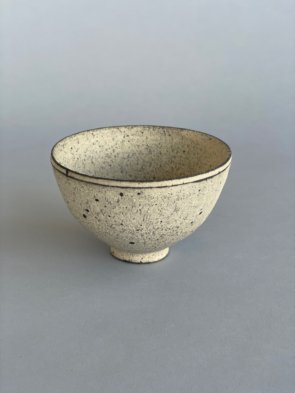 A single ceramic rice bowls. Made by Takashi Endo in a textural white glaze.