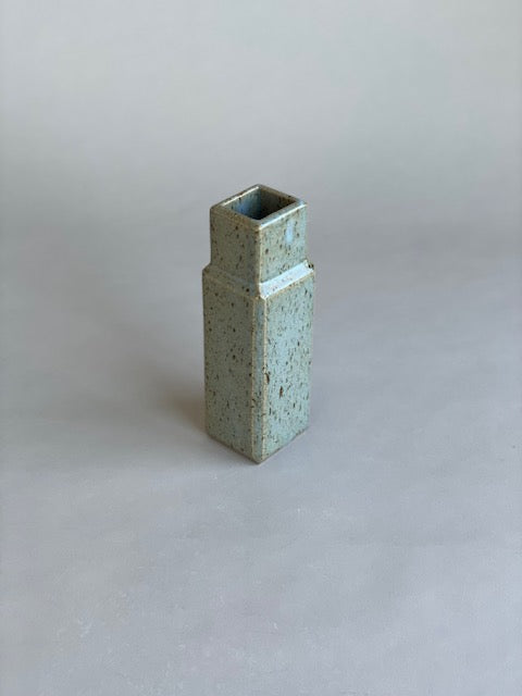 A single column vases by Misma Anaru in an estruscan blue glaze