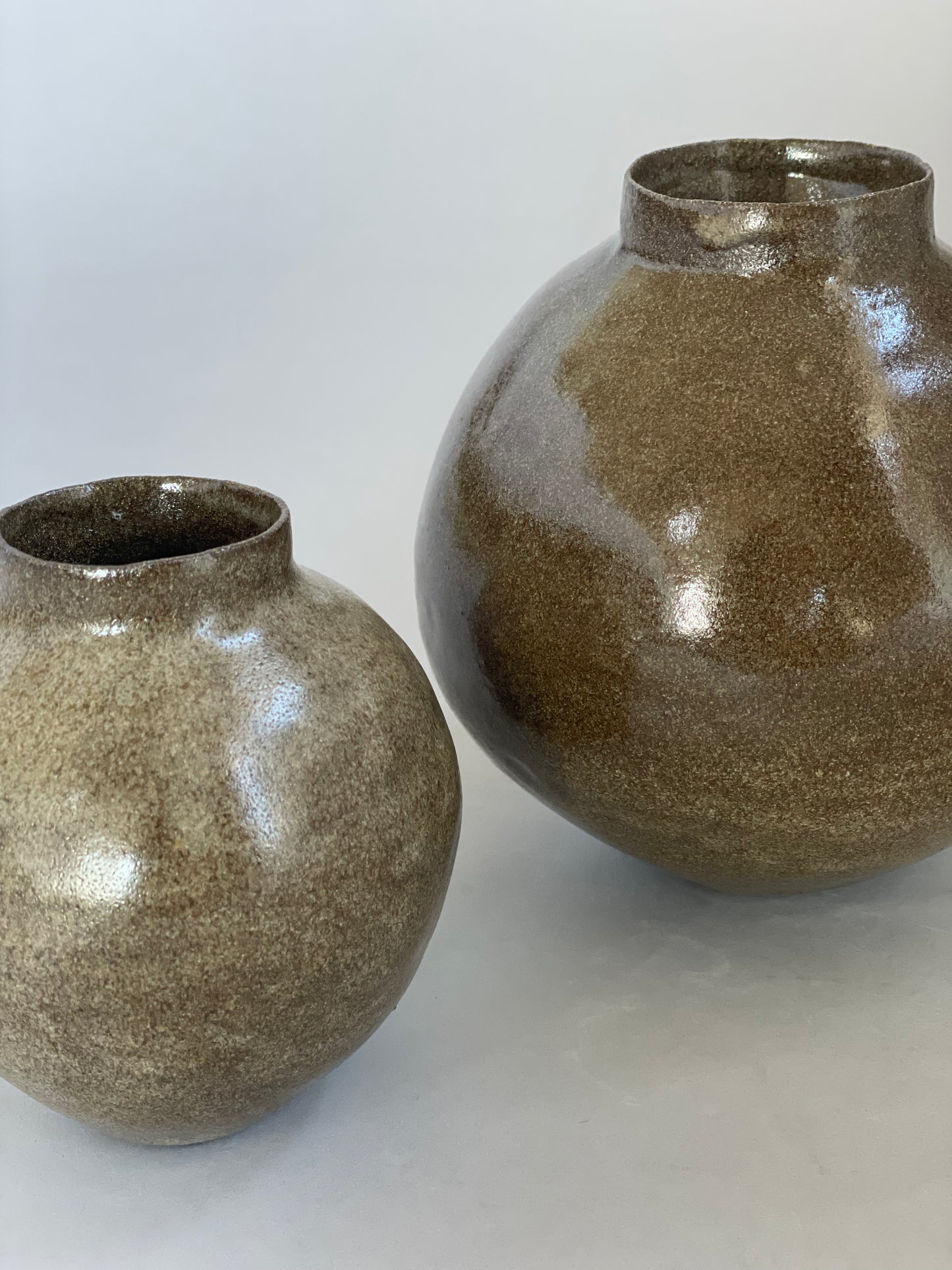 Side view of an organic ceramic vessel with a simple form and earthy tones.