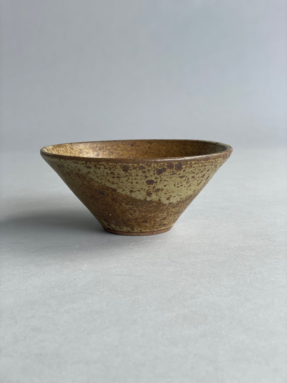 Handmade ceramic bowl with a warm speckled glaze, ideal for serving or pairing with the large Pistachio bowl.
