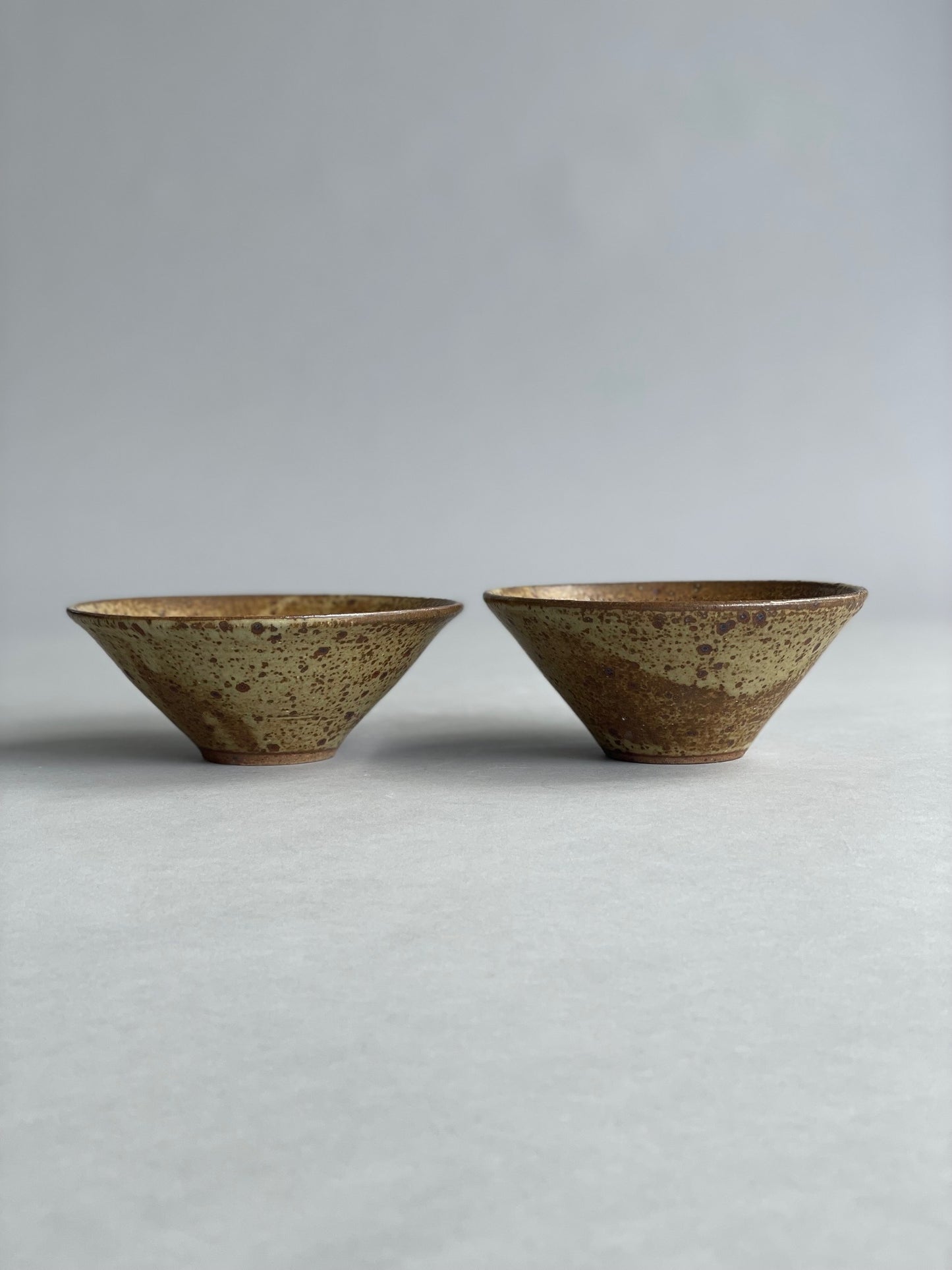Side view of a handmade ceramic bowl, highlighting its smooth finish and minimalist design.