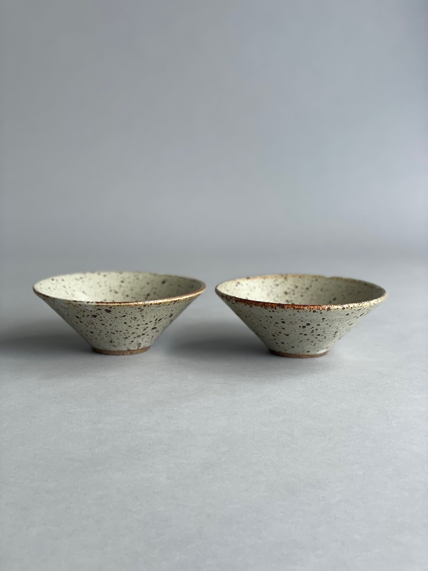 Set of small ceramic bowls on a kitchen counter, ready for serving snacks or side dishes.