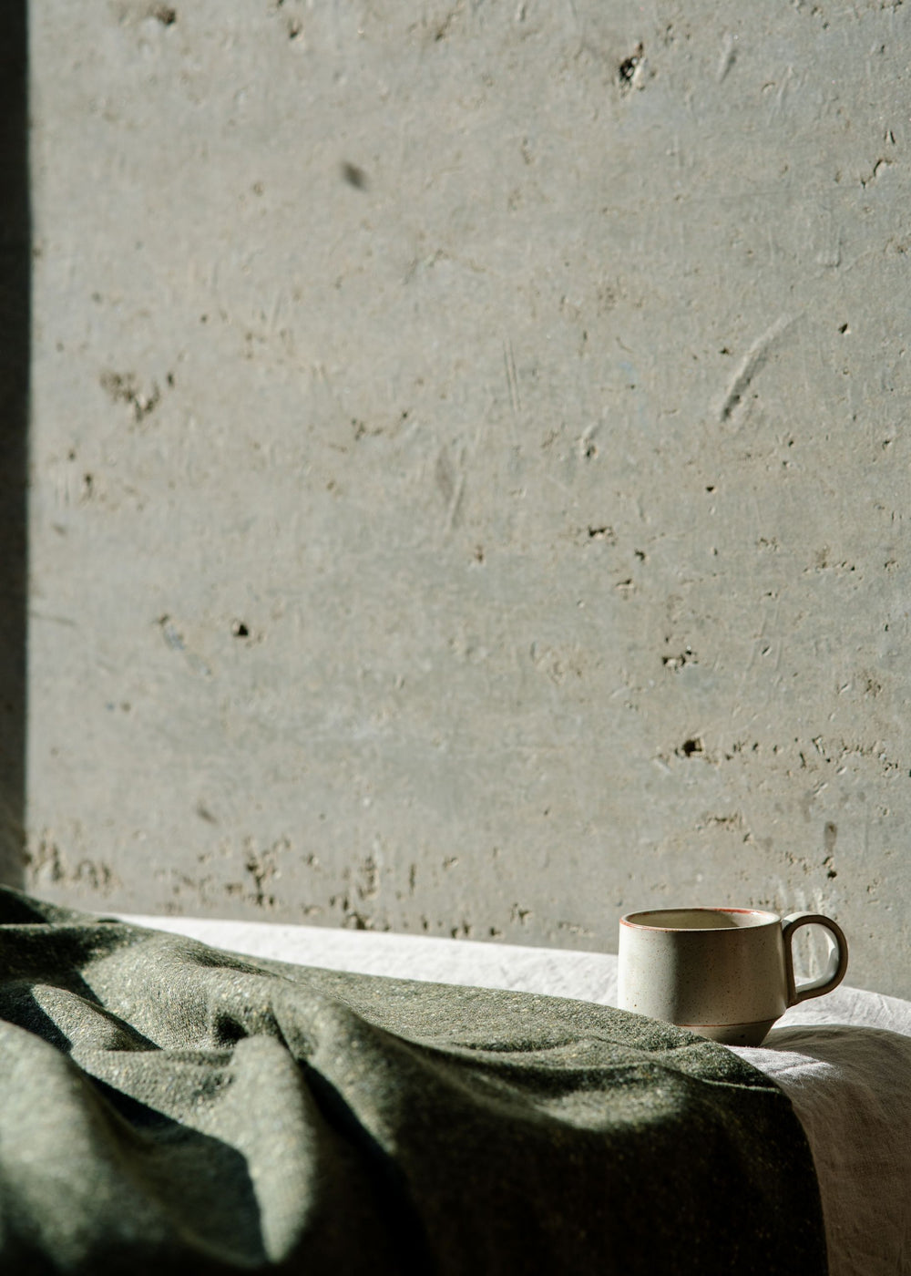 Handmade mug in a soft warm white glaze. A collaboration between potter Richard Beauchamp and SITU Studio. Made in New Zealand