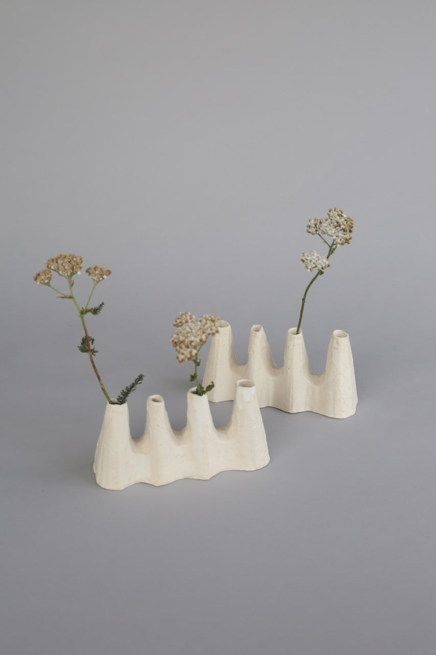 A sculptural white ceramic vases made by artist Kirsten Perry