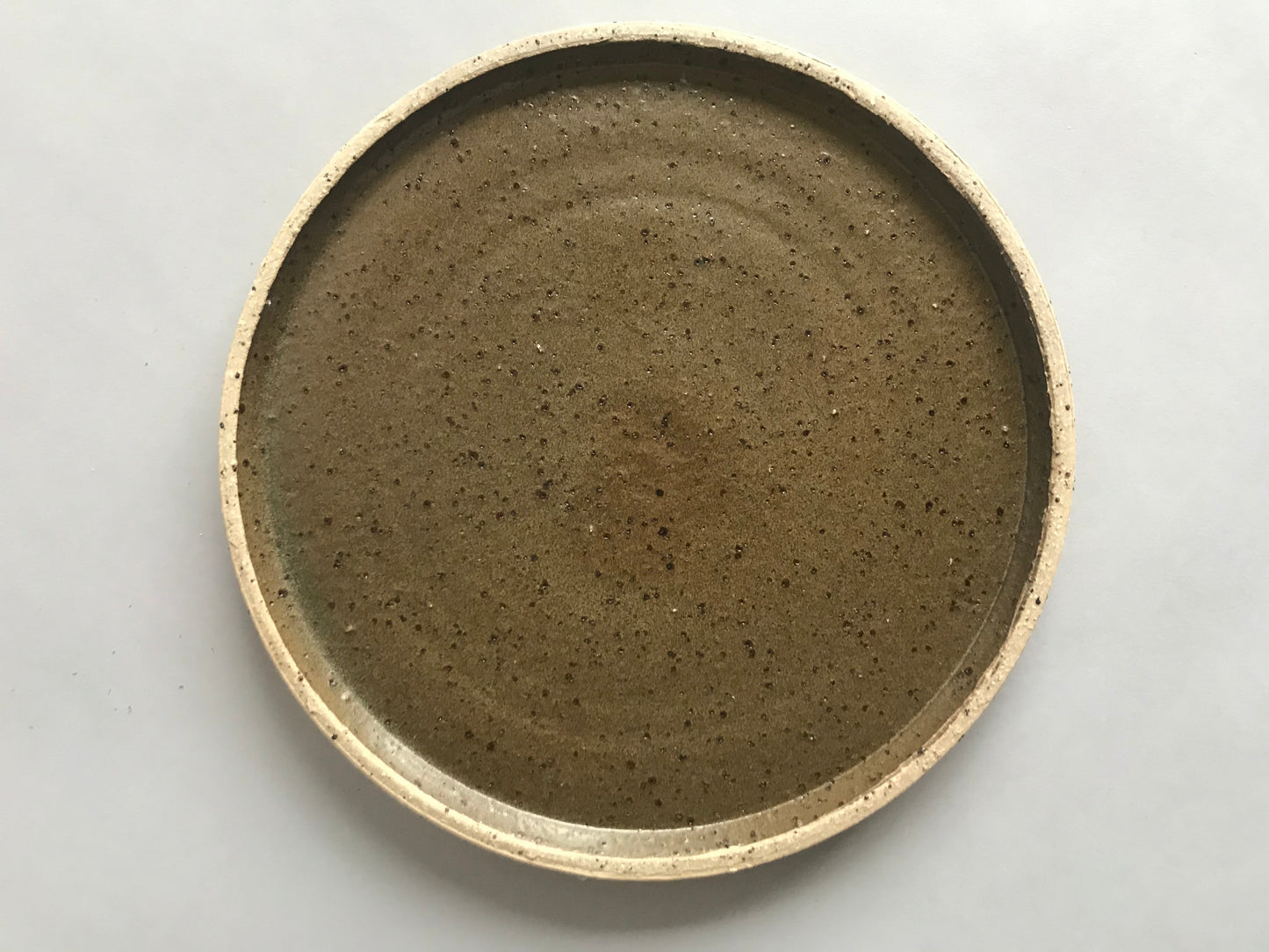 Limited edition handmade ceramic plate. Deep green glaze and a raw textured clay.