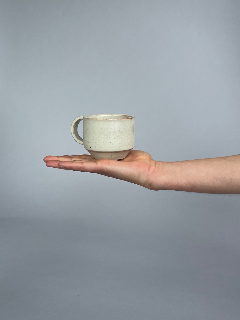 Handmade mug in a soft warm white glaze. A collaboration between potter Richard Beauchamp and SITU Studio. Made in New Zealand
