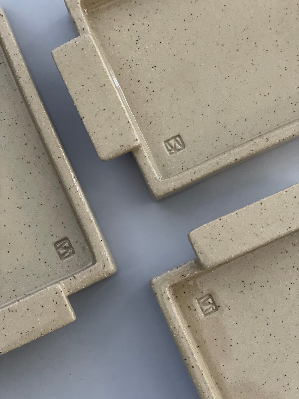 A close up birdseye view of three handmade ceramic butter dish with a lid by Misma Anaru.