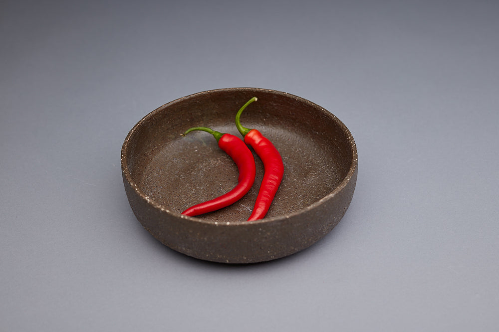 Unique textured bowls handmade by potter Kirsten Dryburgh. Two Chillis are in the bowl