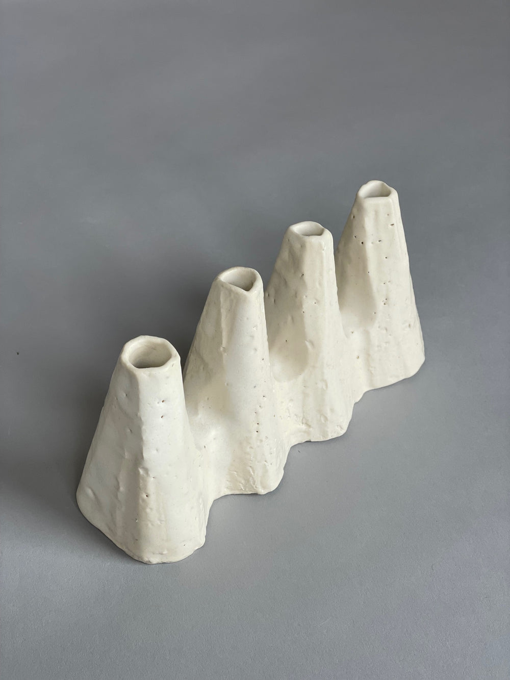A sculptural white ceramic vases made by artist Kirsten Perry