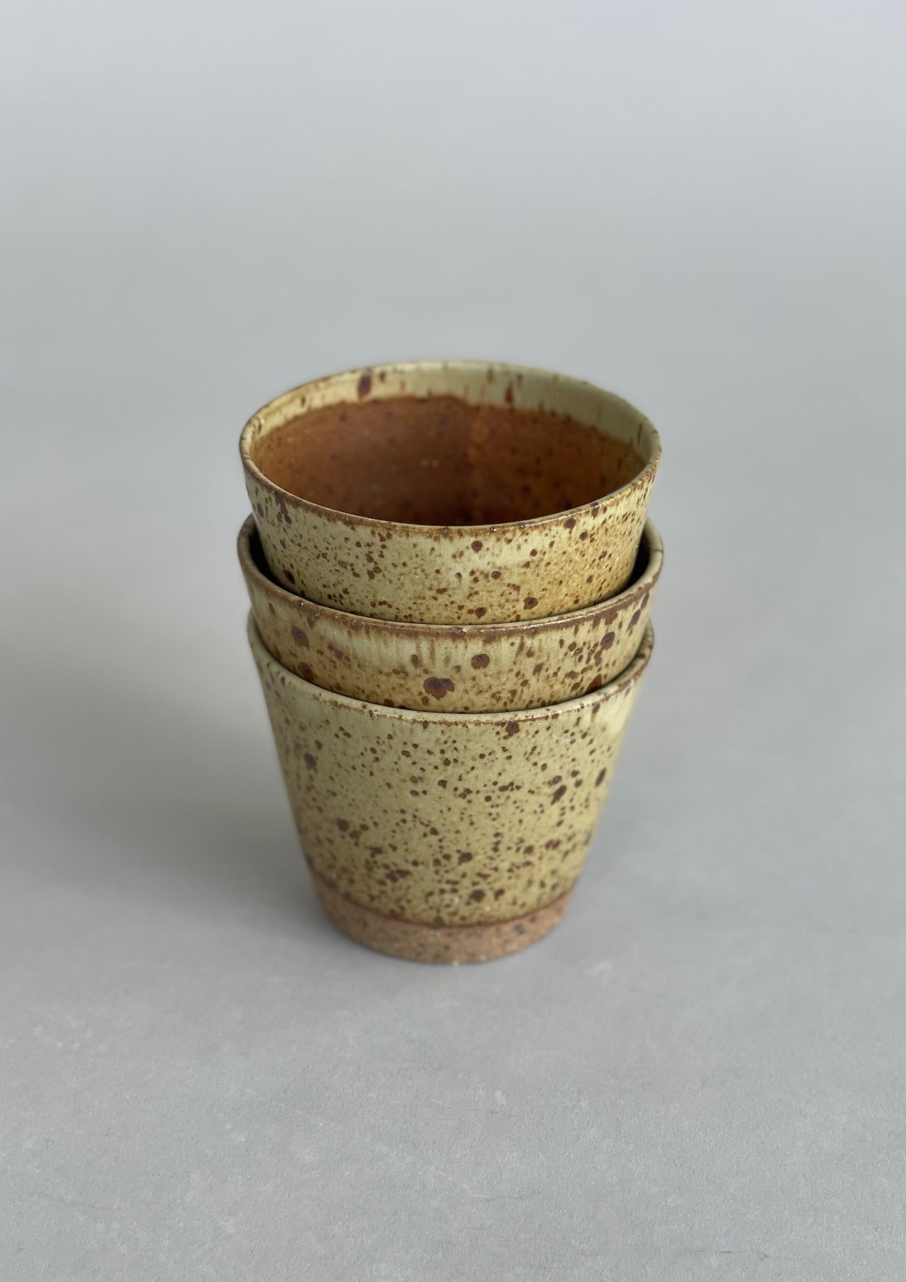 Three ceramic tumblers stacked, perfect for water or hot drinks.