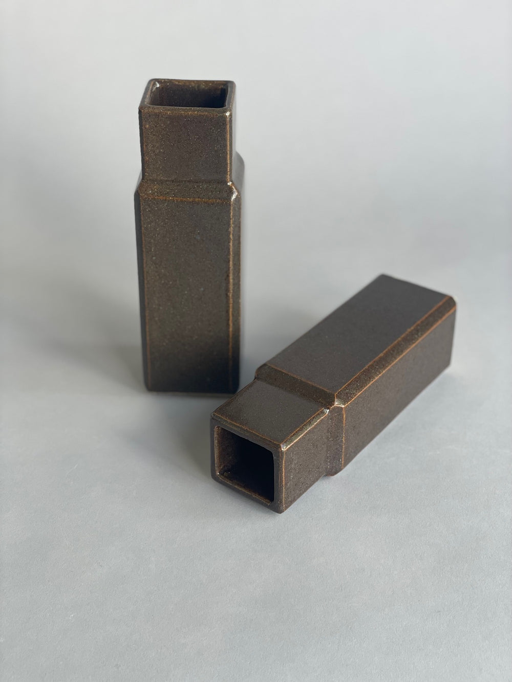 Two column vases by Misma Anaru in an  brown wairepo glaze