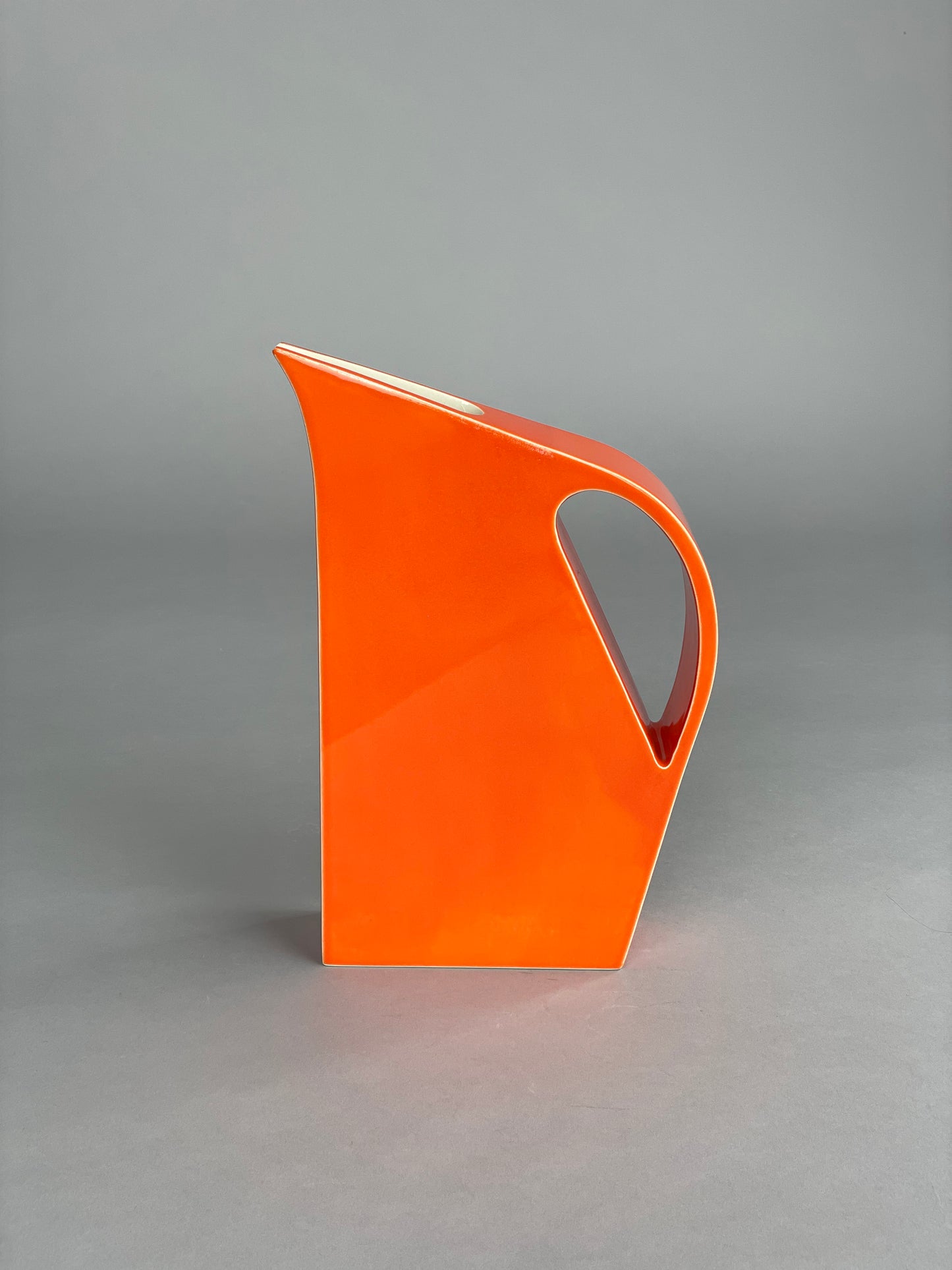 Handmade Tangerine Orange ceramic water jug by potter Yuro Cuchor for SITU Studio. A unique modern shape available in three colours, Orange, Leaf Green, Deep Blue & Brown