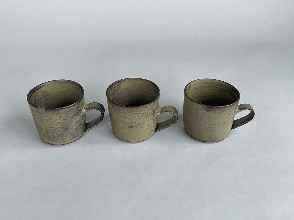 Handmade green cups made for Situ Studio by Wellington potter, Zoe Isaacs.