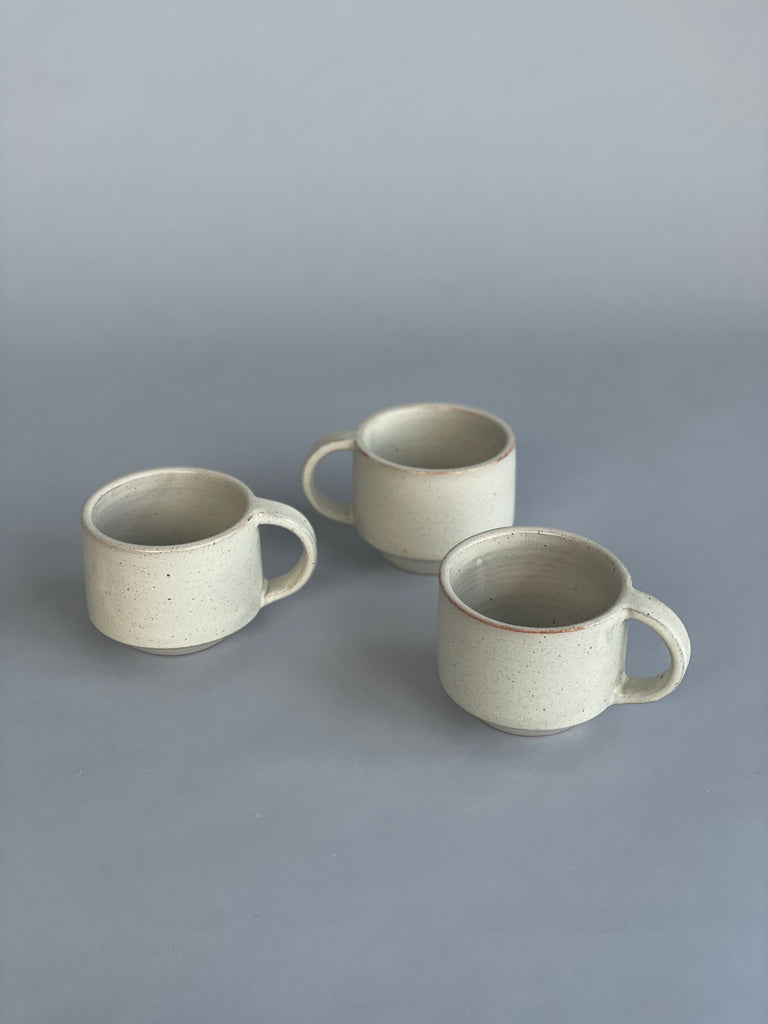 Handmade mug in a soft warm white glaze. A collaboration between potter Richard Beauchamp and SITU Studio. Made in New Zealand