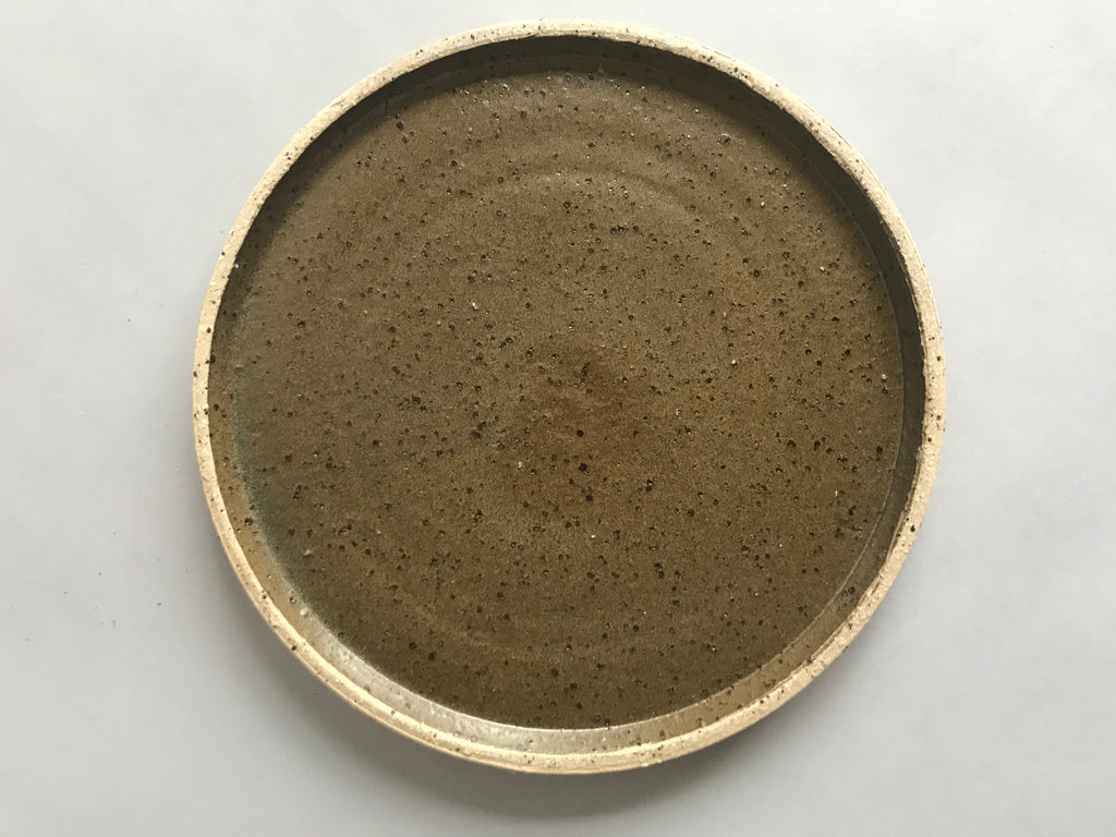 Limited edition handmade ceramic plate. Deep green glaze and a raw textured clay. 