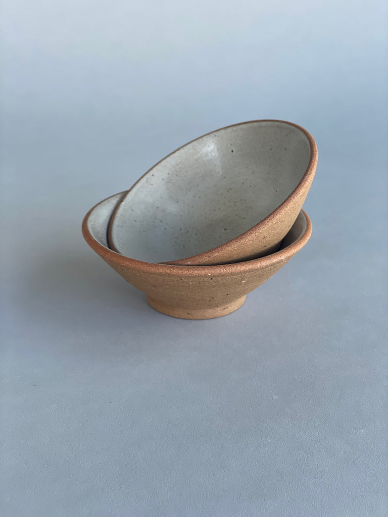 Small handmade ceramic bowls suitable for condiments and snacks. Made in New Zealand for Situ Studio by potter, Nicola Shuttleworth using a warm terracotta clay and a white glaze.