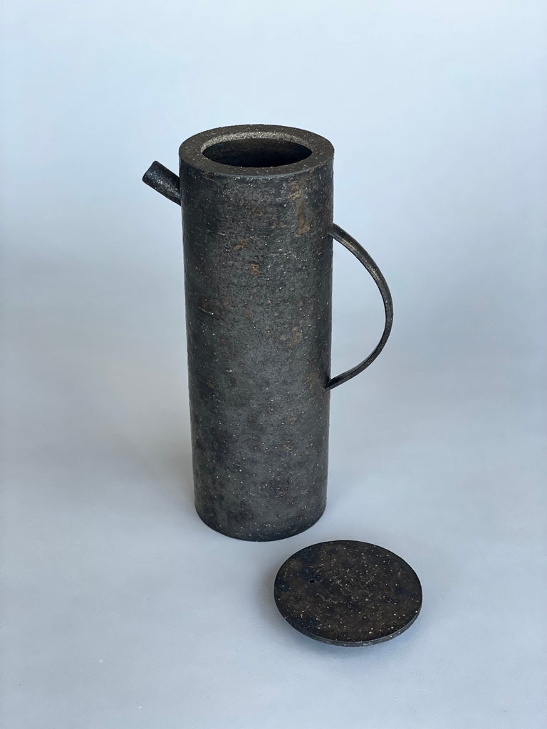 Unique handmade water jug by Japanese ceramic artist, Takashi Endo. A textured black water pot with a refined modern form.