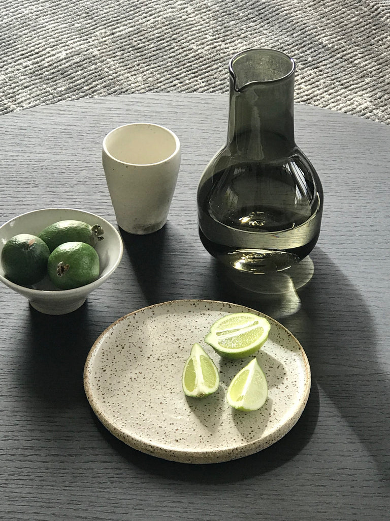 A collection of handmade designer items, including a carafe by Monmouth Glass Studio and ceramic plate by Kirsten Dryburgh both exclusive to Situ Studio.