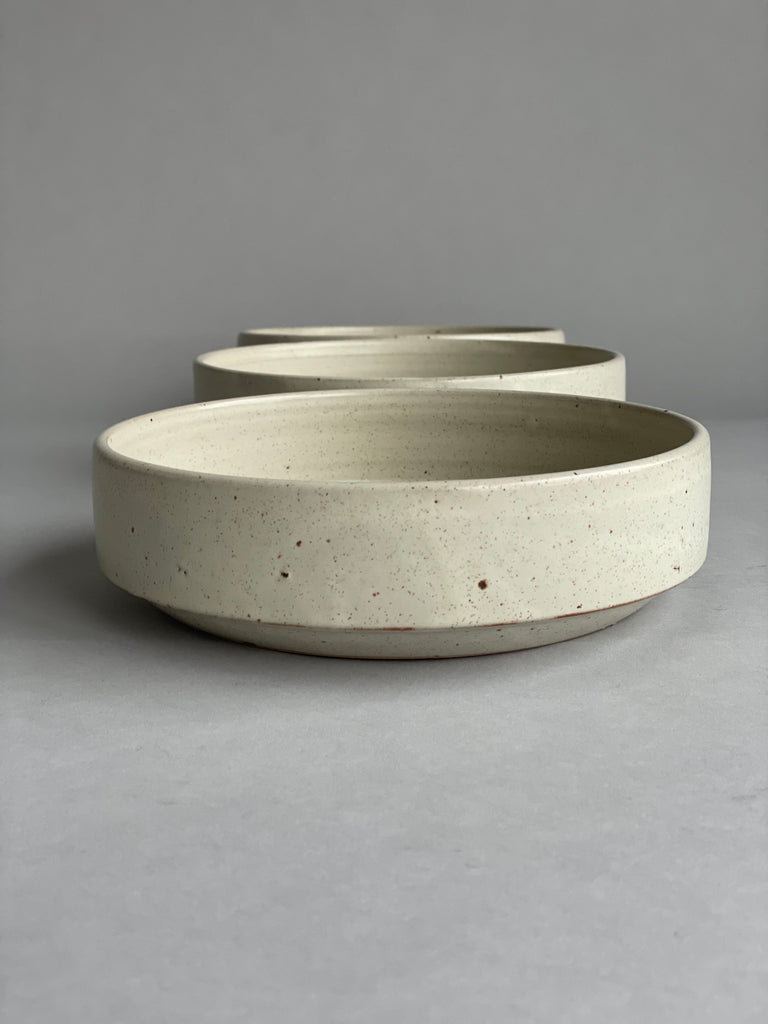 Handmade serving bowl in a warm white glaze. These are made by potter Richard Beauchamp for Situ Studio.