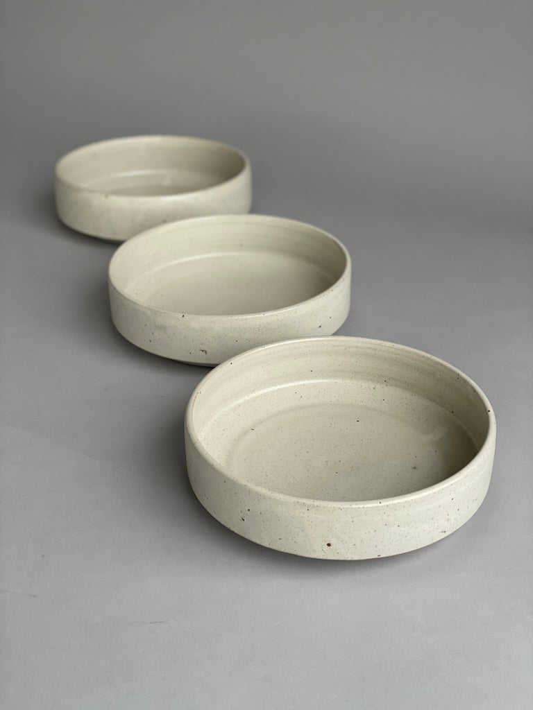 Handmade serving bowl in a warm white glaze. These are made by potter Richard Beauchamp for Situ Studio.