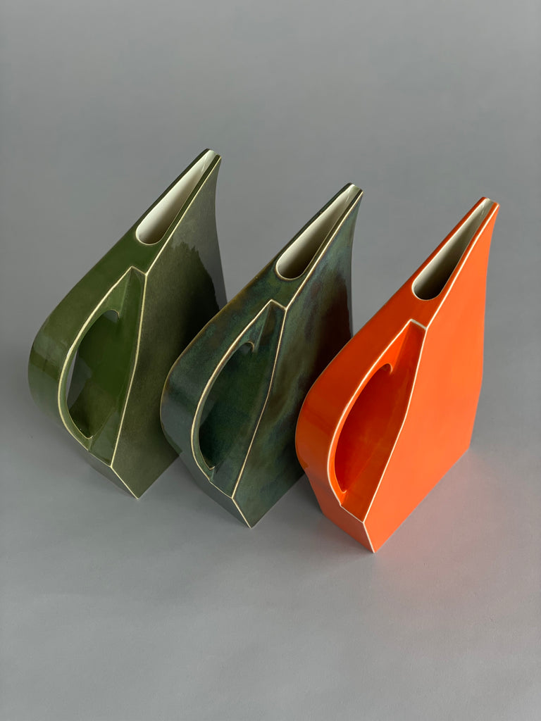 Handmade Tangerine Orange ceramic water jug by potter Yuro Cuchor for SITU Studio. A unique modern shape available in three colours, Orange, Leaf Green & Deep Green