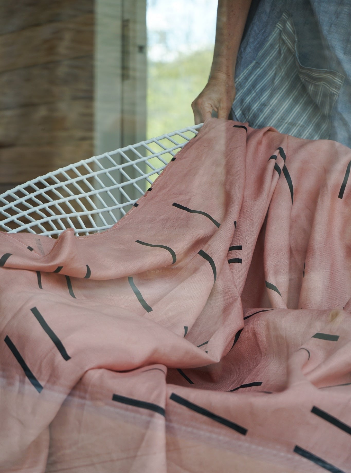 Close-up of a screen-printed linen blanket, emphasizing the calming color palette and organic finish.